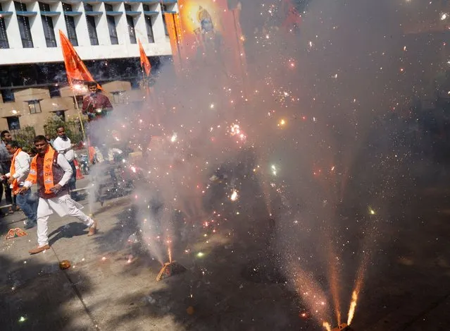 Supporters of India's ruling Bharatiya Janata Party (BJP) light firecrackers during the consecration of the Ram temple in Ayodhya, outside the BJP headquarters in Mumbai, India on January 22, 2024. (Photo by Francis Mascarenhas/Reuters)