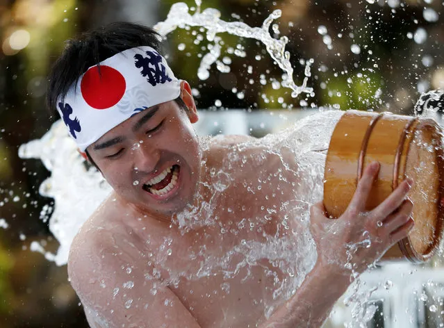 A man splashes himself with cold water during the annual cold water endurance ceremony, to purify his soul and wish for good fortune in the new year, at the Kanda Myojin shrine in Tokyo, Japan January 26, 2019. (Photo by Issei Kato/Reuters)