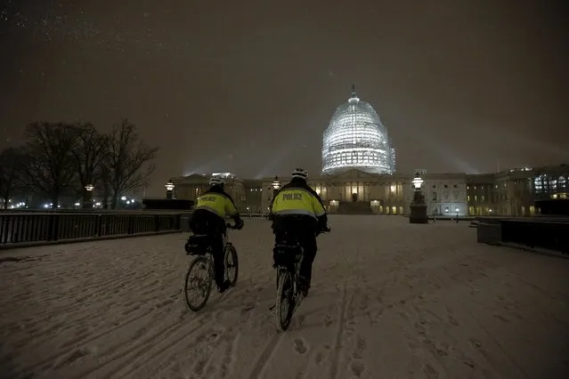U.S. Capitol Police officers patrol on their bicycles in the snow at the U.S. Capitol in Washington January 20, 2016. (Photo by Jonathan Ernst/Reuters)