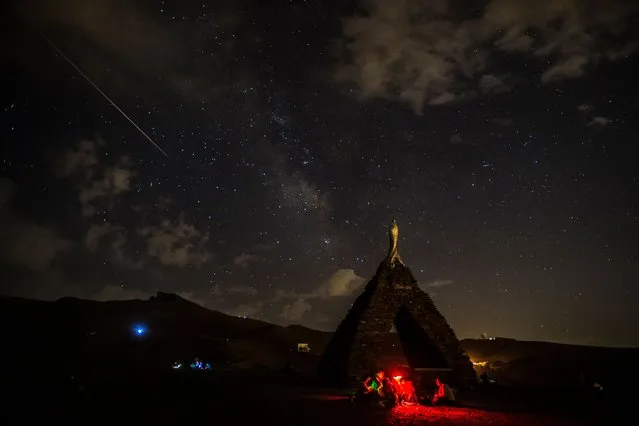A shooting star seen from the sanctuary of the Virgen de las Nieves more than 2,600 meters above sea level on August 12, 2021 in Sierra Nevada, Spain. The annual meteor shower Perseids can be seen between the days of July 17 to August 24 of each year. The most optimal day is August 11. (Photo by Carlos Gil Andreu/Getty Images)