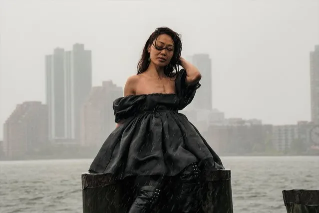 Sabrina Davi poses for photos in Battery Park during Tropical Storm Henri on August 22, 2021 in New York City. A federal storm warning was declared in parts of New England after Hurricane Henri was downgraded from a category 1 hurricane to a tropical storm on Sunday morning. (Photo by David Dee Delgado/Getty Images)