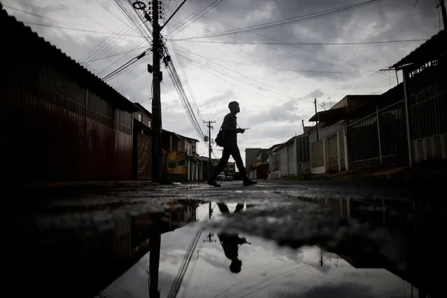 A Brazilian Army soldier walks as soldiers inspect houses to combat the Aedes aegypti mosquito, to help mitigate a dengue outbreak in the Samambaia neighbourhood of Brasilia, Brazil on January 31, 2024. (Photo by Adriano Machado/Reuters)