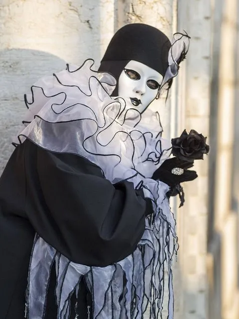 The Carnival of Venice costumes are famous all over the world and include ornate gowns and flowing cloaks, as well as many different masks that can be purchased from temporary stalls or from celebrated artisans who still make them by hand. (Photo by Marco Secchi/Getty Images)