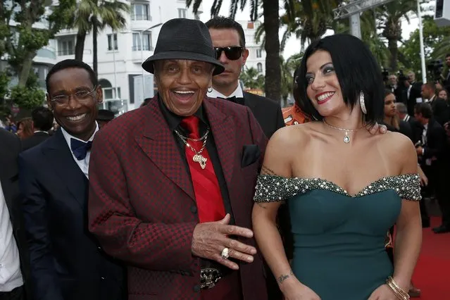 Joe Jackson (C), Michael Jackson's father, and guests pose on the red carpet as they arrive for the screening of the film “Sicario” in competition at the 68th Cannes Film Festival in Cannes, southern France, May 19, 2015. (Photo by Benoit Tessier/Reuters)