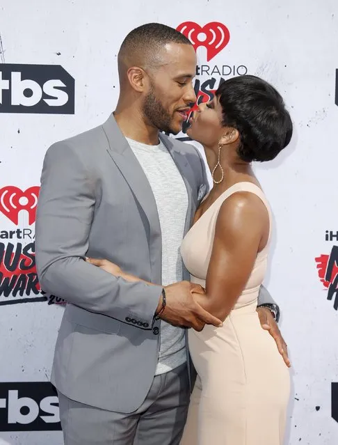 Actress Meagan Good (R) and husband Devon Franklin (L) pose at the 2016 iHeartRadio Music Awards in Inglewood, California, April 3, 2016. (Photo by Danny Moloshok/Reuters)