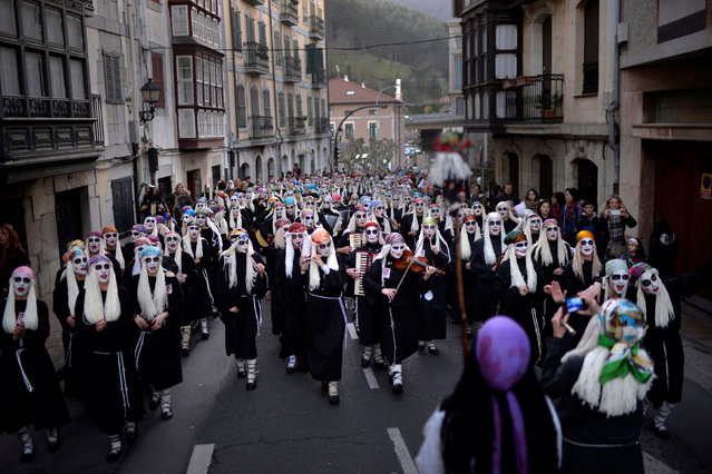 Townswomen dressed as Lamia, Basque mythological creatures, sing and dance in the Basque coastal town of Mundaka, northern Spain, on Carnival Sunday, February 26, 2017. (Photo by Vincent West/Reuters)
