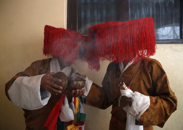 Tibetan men in traditional attire burn incense during a function organised to mark “Losar”, or the Tibetan New Year, in Kathmandu, Nepal March 1, 2017. (Photo by Navesh Chitrakar/Reuters)