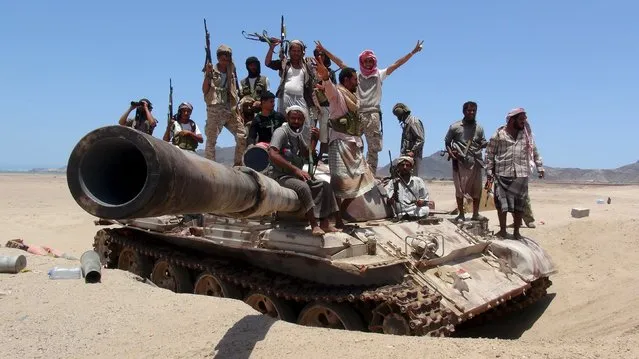 Anti-Houthi fighters of the Southern Popular Resistance stand on a tank in Yemen's southern port city of Aden May 10, 2015. (Photo by Reuters/Stringer)