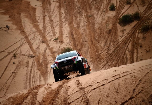 Toyota's driver Yazeed Al Rajhi of Saudi Arabia and co-driver Britain's Michael Orr compete during Stage 3 of the Dakar Rally 2022 between the Saudi areas of al-Artawiya and al-Qaysumah, on January 4, 2022. (Photo by Franck Fife/AFP Photo)