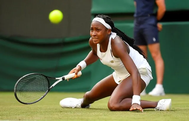 US player Cori Gauff slips as she returns against US player Venus Williams during their women's singles first round match on the first day of the 2019 Wimbledon Championships at The All England Lawn Tennis Club in Wimbledon, southwest London, on July 1, 2019. (Photo by Toby Melville/Reuters)