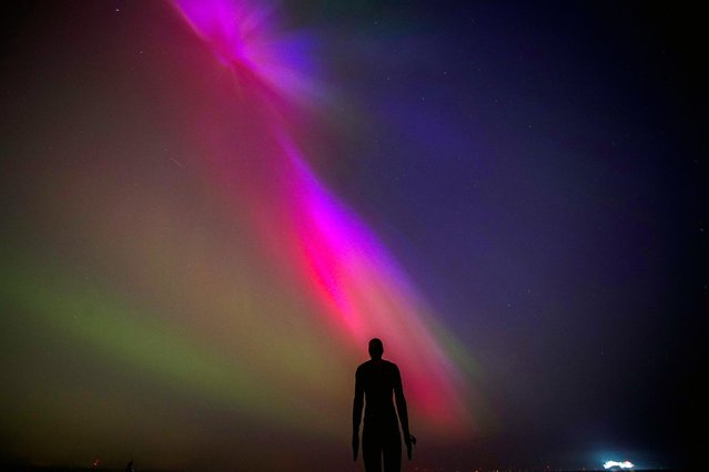 The aurora borealis, also known as the northern lights, glow on the horizon at Another Place by Anthony Gormley, Crosby Beach, Liverpool, Merseyside  on Friday, May 10, 2024. (Photo by Peter Byrne/PA Images via Getty Images)