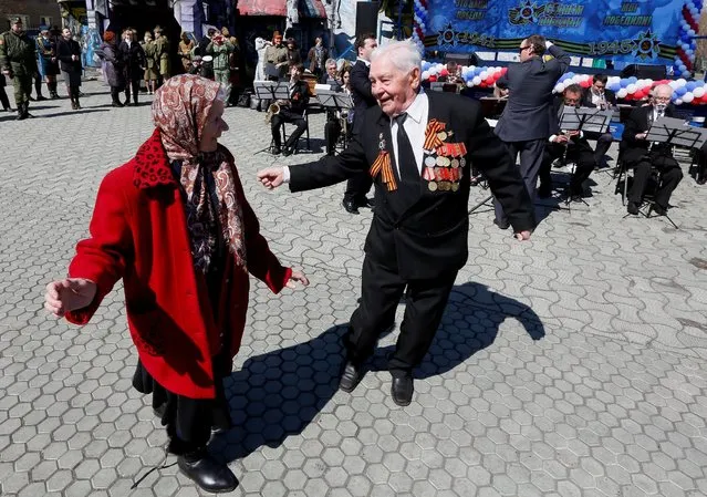 World War Two veteran Anatoly Zamyatin, 91, takes part in an open air dancing event ahead of Victory Day at Gagarin Park in Krasnoyarsk, Siberia, Russia, May 5, 2016. (Photo by Ilya Naymushin/Reuters)