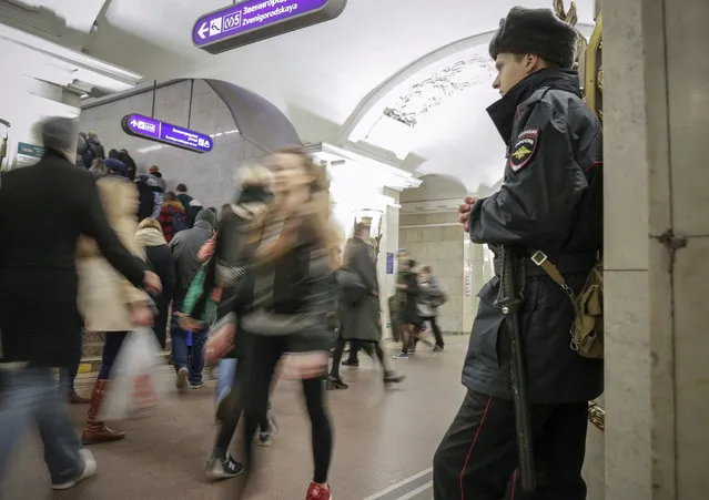 Policeman patrols at Pushkinskaya subway station in St.Petersburg, Russia, Friday, April 7, 2017. A bomb blast tore through a subway train under Russia's second-largest city on Monday, killing many people and wounding many others. Eight members of extremist cells have been arrested in connection with last week's deadly bombing on the subway in St. Petersburg, Russia's intelligence chief said Tuesday. (Photo by Dmitri Lovetsky/AP Photo)