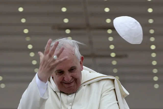 A gust of wind blows off Pope Francis' cap during his weekly general audience at St. Peter's Square at the Vatican April 30, 2014. (Photo by Alessandro Bianchi/Reuters)