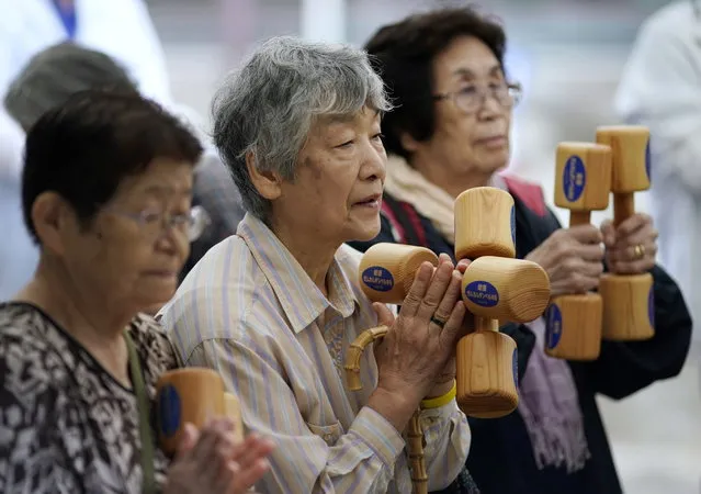 Elderly people practice physical activity with wooden dumbbells during an event marking the 'Respect for the Aged Day' in Tokyo, Japan, 16 September 2019. According to government data released on 15 September, 35.88 million people are aged 65 or older in Japan, representing a record 28.4 percent of the population. Japan has the oldest population in the world. (Photo by Franck Robichon/EPA/EFE)