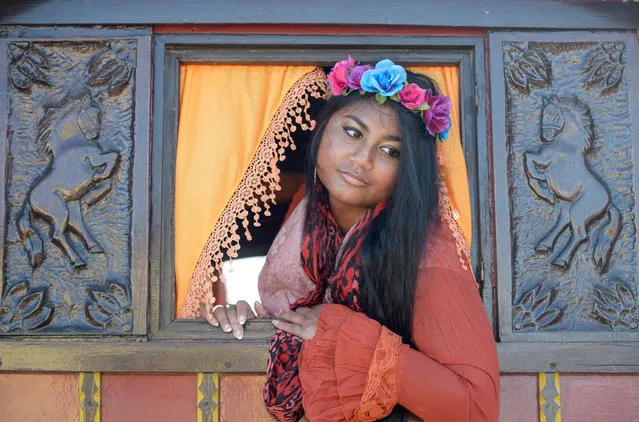 Marie Lou looks out of the window of gypsy folklore wagon on May 24, 2016 in Staintes Maries de la Mere near Arles, France. (Photo by Thomas Lohnes/Getty Images)