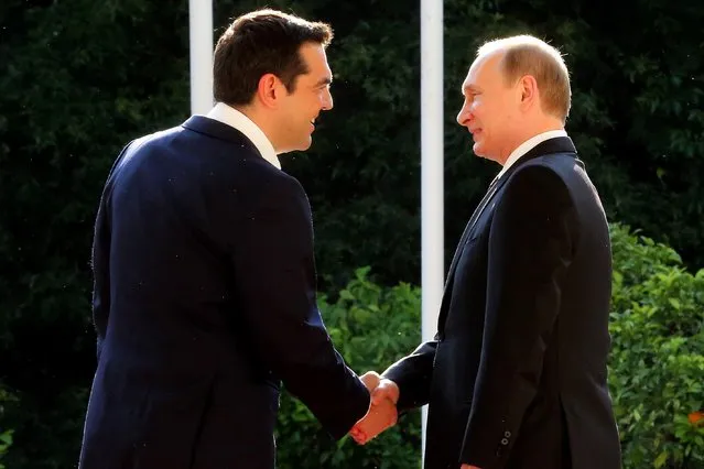 Greek Prime Minister Alexis Tsipras, left, welcomes Russian President Vladimir Putin at the Maximos Mansion in Athens, Friday, May 27, 2016. (Photo by Orestis Panagiotou/EPA via AP Photo)