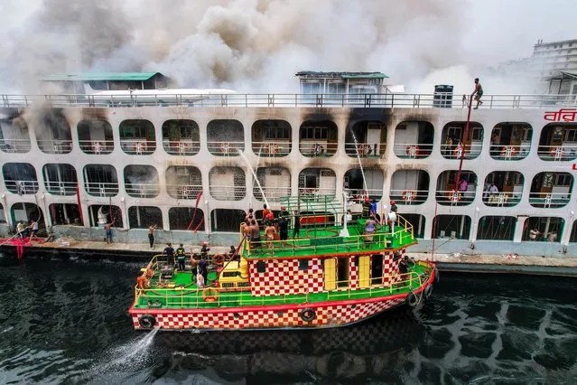 Firefighters work to bring a blaze on a passenger ship under control in Dhaka, Bangladesh on March 27, 2022. Earlier on 24 December, at least 40 people died after a fire broke out in “MV Abhijan-10”, a river ferry, on the River Sugandha in Jhalakathi. Passengers who escaped from the fire incident said the fire broke out from the canteen and engine room and continued for hours. The reason behind the fire could not be ascertained immediately. This is one of the biggest ferry in Bangladesh. (Photo by Mustasinur Rahman Alvi/ZUMA Press Wire/Rex Features/Shutterstock)