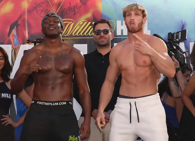 Logan Paul (R) mocks and imitates KSI while promoter Eddie Hearn looks on after the official weigh-in at L.A. Live Xbox Plaza on November 08, 2019 in Los Angeles, California. (Photo by Victor Decolongon/Getty Images)