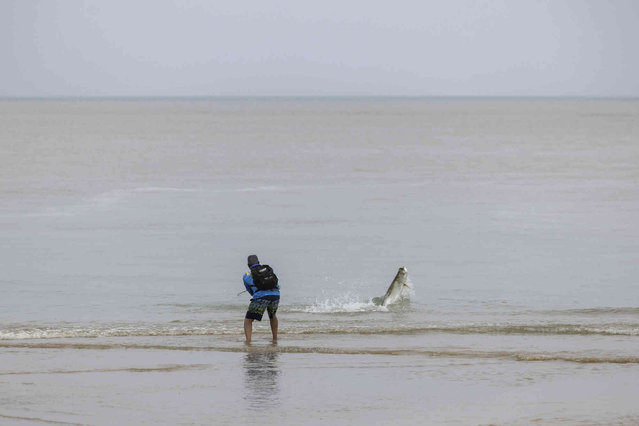 A man fishes after Tropical Storm Ernesto passed through Rio Grande, Puerto Rico, Wednesday, August 14, 2024. (Photo by Alejandro Granadillo/AP Photo)