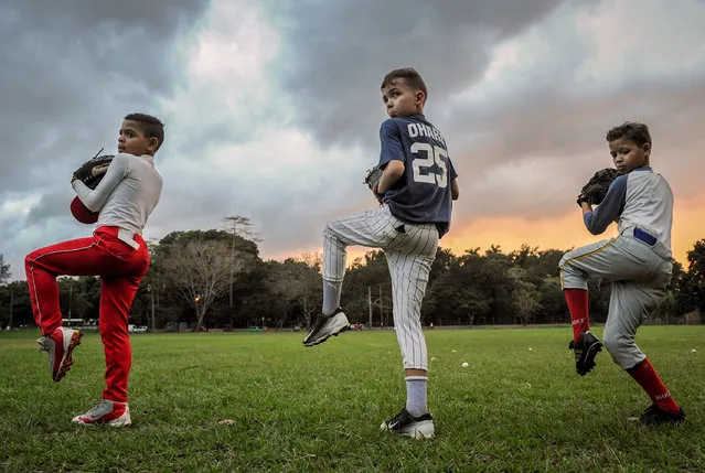 Cuban children are pictured during a baseball trainning session in Havana, on February 7, 2017. (Photo by Yamil Lage/AFP Photo)