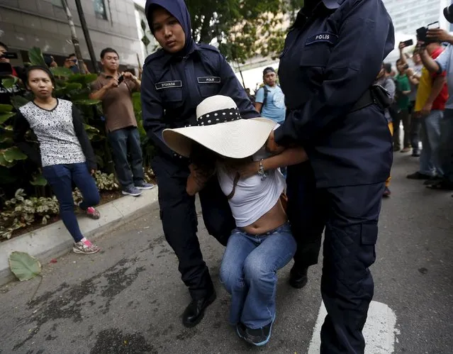 A demonstrator is detained during a protest against Malaysian Prime Minister Najib Razak in Kuala Lumpur, Malaysia, August 1, 2015. Over 20 protesters were arrested after calling for Najib to resign, local media reported. (Photo by Olivia Harris/Reuters)