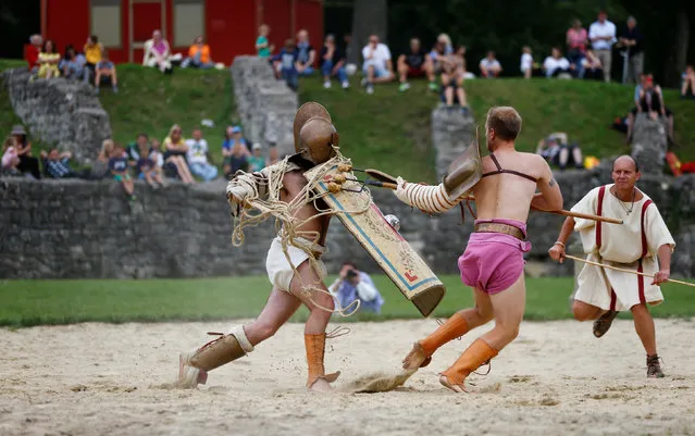 Members of the “Familia Gladiatoria Carnuntina” fight in the historic amphitheatre during the Roman Festival at the archeological site of Carnuntum in Petronell, Austria, June 11, 2016. (Photo by Leonhard Foeger/Reuters)