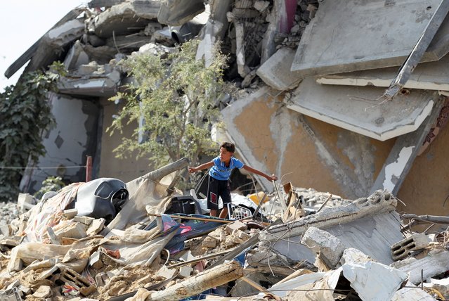 A boy gestures as he stands among rubble, after Israeli forces withdrew from the area, following a ground operation, amid the ongoing conflict between Israel and Hamas, in Khan Younis, in the southern Gaza Strip, on August 30, 2024. (Photo by Hatem Khaled/Reuters)