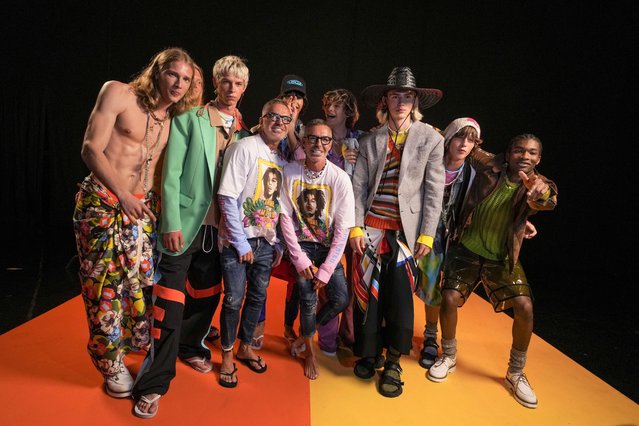 Canadian fashion designers Dean Caten, centre left, and Dan Caten, centre right, pose with models backstage after the Dsquared2 men's Spring Summer 2023 collection presented in Milan, Italy, Friday, June 17, 2022. (Photo by Luca Bruno/AP Photo)