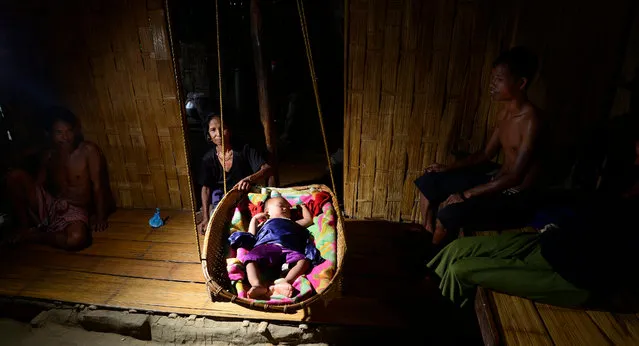 A photograph made available on 19 June 2016 shows a newly-born Bru baby in a refugee camp with the family on the eve of the World Refugee Day in Kanchanpur sub division in Tripura state, India, 18 June 2016. Bru tribe crossed over from Mizoram to Tripura in 1997 following alleged atrocities committed against them by Mizos. Over 32,000 Bru refugees are still languishing in seven makeshift camps in Tripura. Ministry of Home Affairs has recently informed that the Brus lodged in the relief camps in North Tripura district they will be given six months deadline for returning to Mizoram and the names of those who still refuse to be repatriated should be deleted from the Mizoram voters' lists. (Photo by EPA/Stringer)