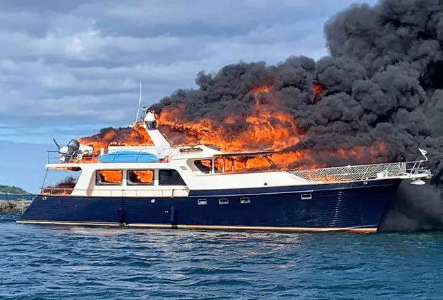 This image provided by New Hampshire State Police shows a yacht burning on the Piscataqua River in New Castle, N.H., Saturday, June 18, 2022. (Photo by New Hampshire State Police via AP Photo)