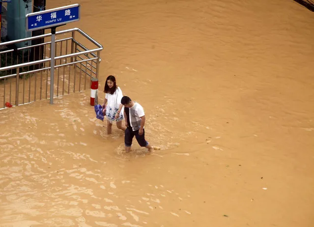 Residents walk at a flooded area as Typhoon Nepartak brings heavy rainfall in Putian, Fujian Province, China, July 9, 2016. (Photo by Reuters/Stringer)