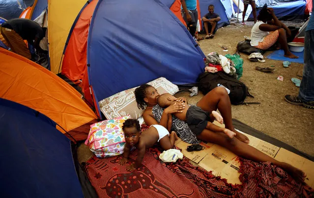 An African migrant stranded in Costa Rica, rests with her children at makeshift camp at the border between Costa Rica and Nicaragua, in Penas Blancas, Costa Rica, July 14, 2016. (Photo by Juan Carlos Ulate/Reuters)