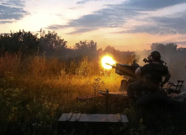A Ukrainian serviceman fires with a ZU-23-2 anti-aircraft cannon at a position near a front line in the Kharkiv region, as Russia's attack on Ukraine continues, Ukraine on August 10, 2022. (Photo by Vyacheslav Madiyevskyy/Reuters)
