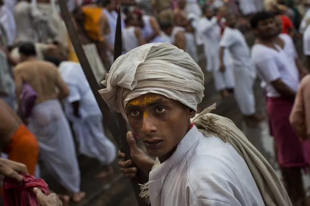 An Hindu devotee prior taking a bath the Godavari River during Kumbh Mela, or Pitcher Festival, in Nasik, India, Saturday, August 29, 2015. (Photo by Bernat Armangue/AP Photo)