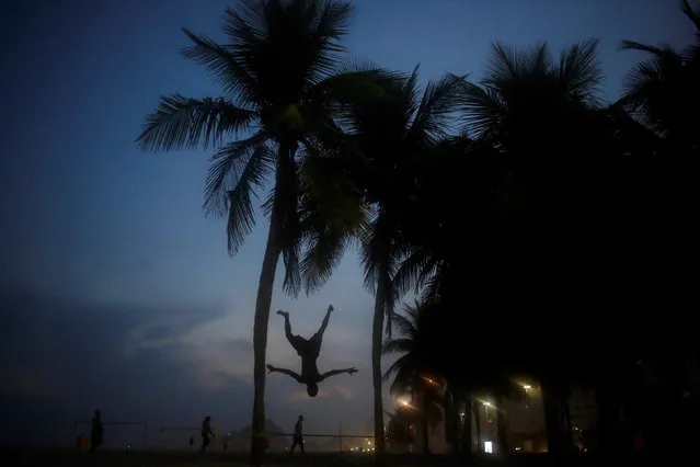 A man practices on a slackline, on Leme beach in Rio de Janeiro, Brazil, May 9, 2016. (Photo by Nacho Doce/Reuters)