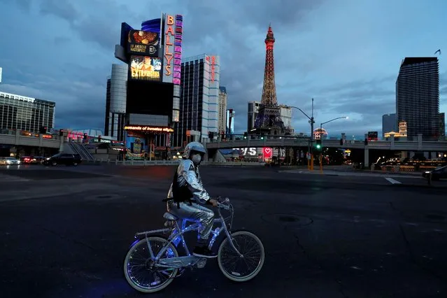 A man stands on his bicycle on the Las Vegas strip as the spread of coronavirus disease (COVID-19) continues, in Las Vegas, Nevada U.S., April 10, 2020. (Photo by Shannon Stapleton/Reuters)