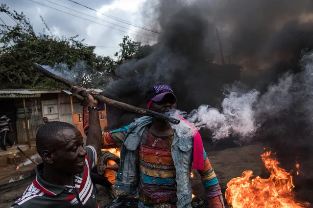 Opposition supporters burn tires in protest for presidential candidate Raila Odinga, in the Kibera slum on October 25, 2017 in Nairobi, Kenya. (Photo by Andrew Renneisen/Getty Images)