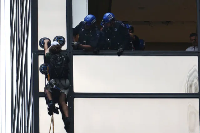 New York Police prepare to pull a climber into a window of Trump Tower in the Manhattan borough of New York, U.S., August 10, 2016. (Photo by Carlo Allegri/Reuters)