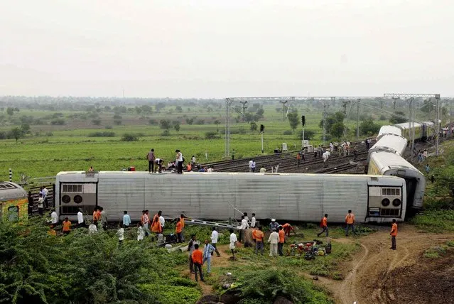 People gather at the site of a train accident at Martur, in Gulbarga district, about 600 kilometers (370 miles) north of India's technology hub of Bangalore, Saturday, September 12, 2015. Two trains derailed in India on Saturday. The other incident happened near the northern hill town of Kalka, in Himachal Pradesh state after three coaches of a special tourist train went off the tracks. (Photo by AP Photo)