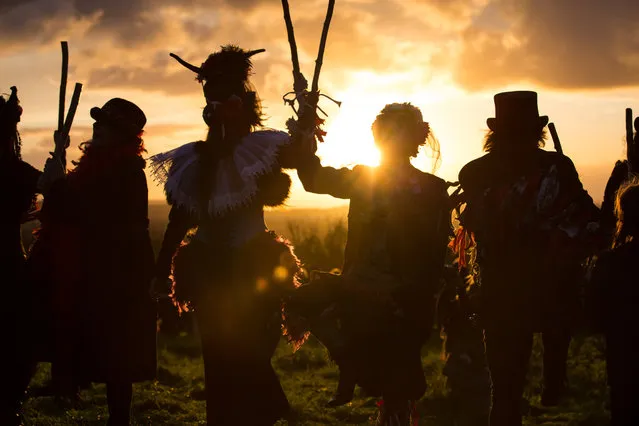 The Glastonbury Border Morris dance at sunset as they celebrate Samhain at the Glastonbury Dragons Samhain Wild Hunt 2017 in Glastonbury on November 4, 2017 in Somerset, England. (Photo by Matt Cardy/Getty Images)