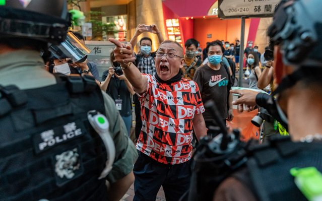A pro-democracy supporter shouts at riot police during an anti-national security law rally in Mongkok district on June 12, 2020 in Hong Kong, China. Protesters heeded online calls to gather as the city marks the one-year anniversary of the major clashes between police and pro-democracy demonstrators over the controversial extradition bill. (Photo by Anthony Kwan/Getty Images)