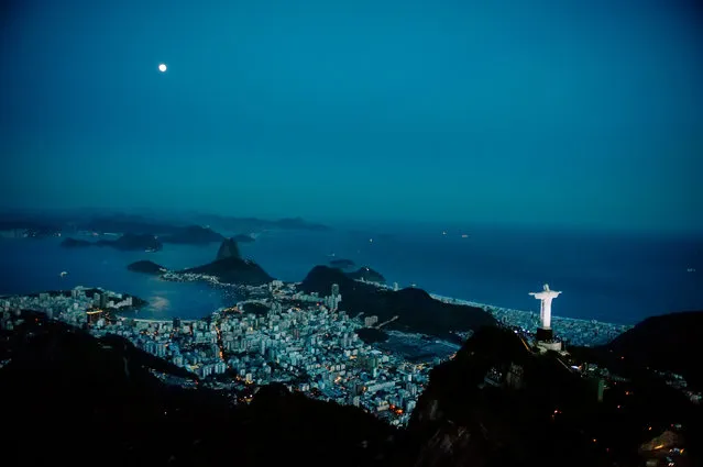Corcovado with its iconic Christ the Redeemer statue overlooking Rio de Janiero. “Visible from nearly every part of the city, and here sharing the skyline with the moon”. (Photo by David Alan Harvey/Magnum Photos/The Guardian)