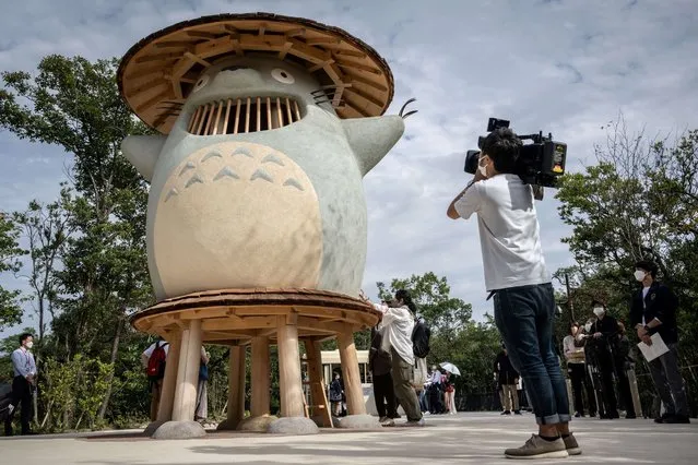 A member of the media takes video of an exhibit of Ghibli character “Totoro” at Dondoko Forest during a media tour of the new Ghibli Park in Nagakute, Aichi prefecture on October 12, 2022. The media on October 12 got a sneak peek at the highly anticipated new theme park from Studio Ghibli, creator of beloved titles like “My Neighbour Totoro” and Oscar-winning “Spirited Away”. (Photo by Yuichi Yamazaki/AFP Photo)