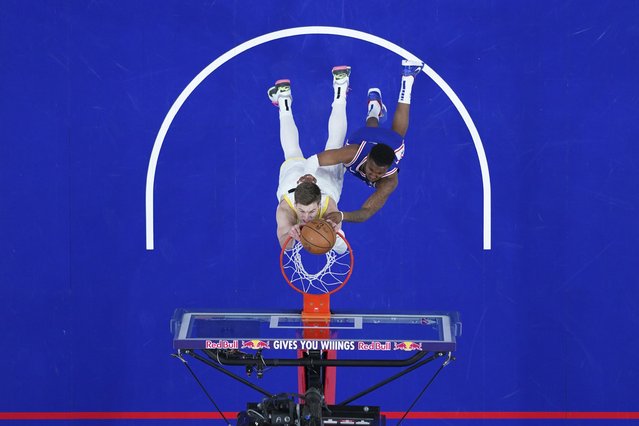 Utah Jazz's Kyle Filipowski, left, dunks against Philadelphia 76ers' Justin Edwards during the first half of an NBA basketball game Sunday, March 9, 2025, in Philadelphia. (Photo by Matt Slocum/AP Photo)