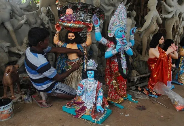 An artisan puts the finishing touches to an idol of Hindu Lord Krishna at a workshop in Agartala, India, August 23, 2016. (Photo by Jitendra Prakash/Reuters)