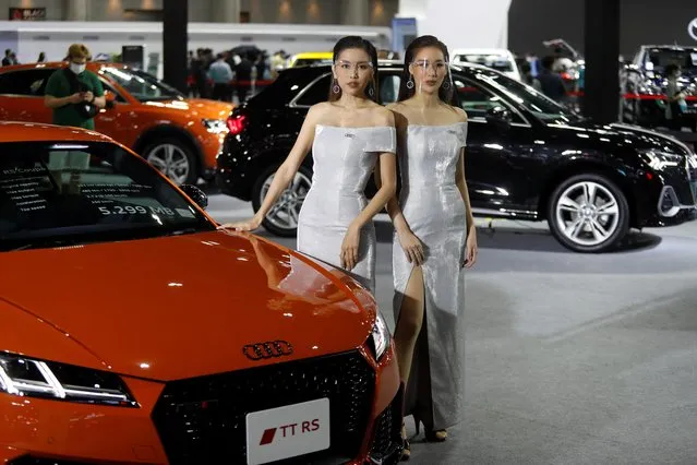 Models wearing face shields pose with an Audi TT RS Coupe during the media day of the 41st Bangkok International Motor Show after the Thai government eased measures to prevent the spread of the coronavirus disease (COVID-19) in Bangkok, Thailand on July 14, 2020. (Photo by Jorge Silva/Reuters)