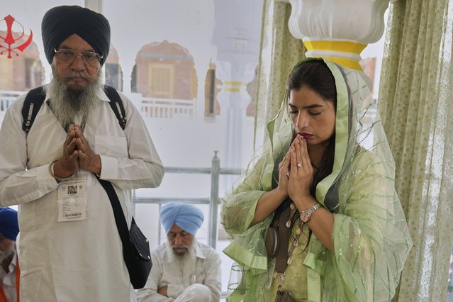Sikh pilgrims perform rituals at a ceremony to mark the Vaisakhi festival at the shrine of Gurdwara Janam Asthan in Nankana Sahib, some 75 kilometres (46 miles) west of Lahore, Pakistan, Monday, April 14, 2024. (Photo by K.M. Chaudary/AP Photo)