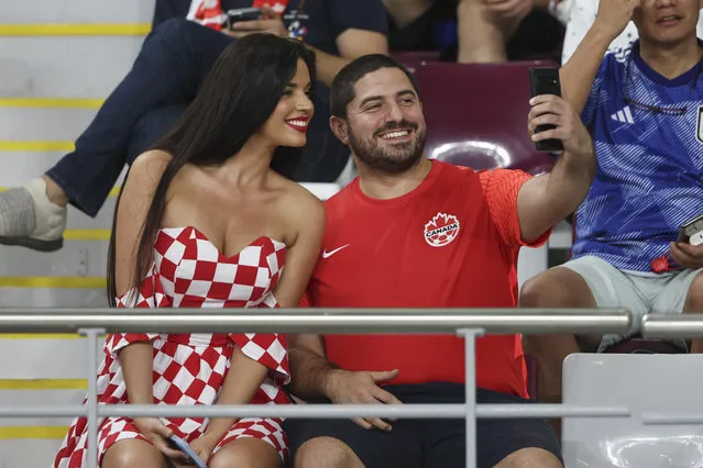 A fan of Canada takes a selfie with former Miss Croatia Ivana Knoll who attends the game during the FIFA World Cup Qatar 2022 Group F match between Croatia and Canada at Khalifa International Stadium on November 27, 2022 in Doha, Qatar. (Photo by Matthew Ashton – AMA/Getty Images)
