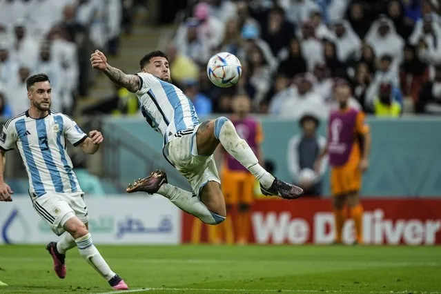 Argentina's Nicolas Otamendi tries to score in front go his teammate Nicolas Tagliafico during the World Cup quarterfinal soccer match between the Netherlands and Argentina, at the Lusail Stadium in Lusail, Qatar, Friday, December 9, 2022. (Photo by Jorge Saenz/AP Photo)